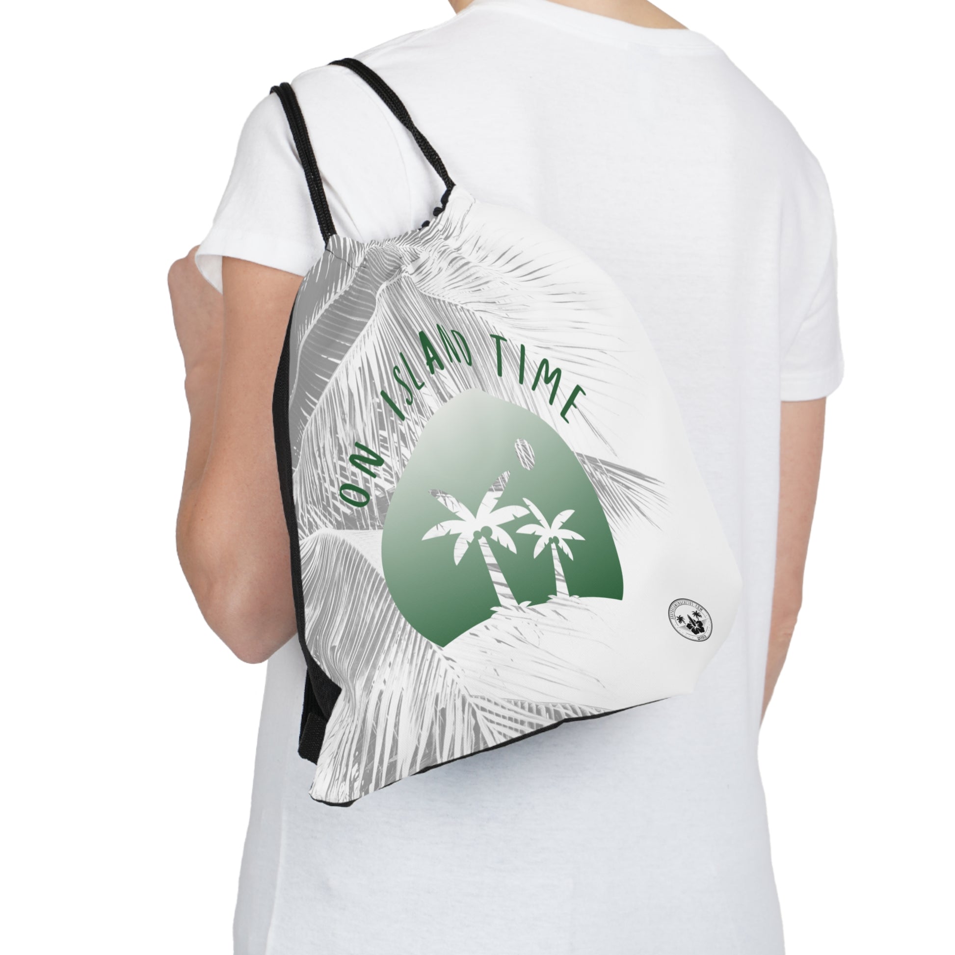 A Daydreaming Cactus created the ultimate travel companion drawstring backpack combines functionality with style, featuring a vibrant gradient green simple graphic of two palmtrees on an island  and grey tone palm tree background with the text "On Island Time" design. Perfect for on-the-go adventurers, this lightweight backpack is ideal for storing essentials while exploring. Grab yours now for an unforgettable journey! This image is front view of the backpack over the shoulder of a model..