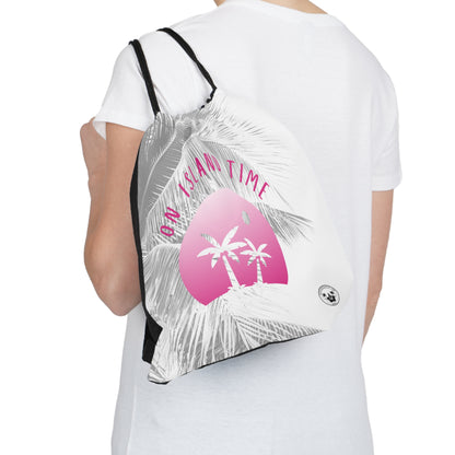 A Daydreaming Cactus created the ultimate travel companion drawstring backpack combines functionality with style, featuring a vibrant gradient pink simple graphic of two palmtrees on an island  and grey tone palm tree background with the text "On Island Time" design. Perfect for on-the-go adventurers, this lightweight backpack is ideal for storing essentials while exploring. Grab yours now for an unforgettable journey! This image is front view of the backpack over the shoulder of a model.