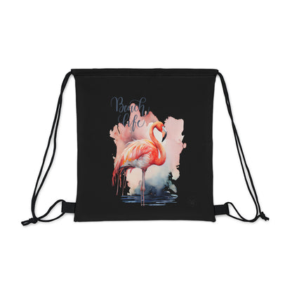 Unleash your wanderlust with our versatile drawstring backpack! Embrace travel with ease and style, flaunting a Beach Life Flamingo graphic with bright color backgrounds. This one is a black background. Designed for adventurers, it's the perfect blend of practicality and fashion. Get yours today for your next adventure! This is a front view of the backpack. 