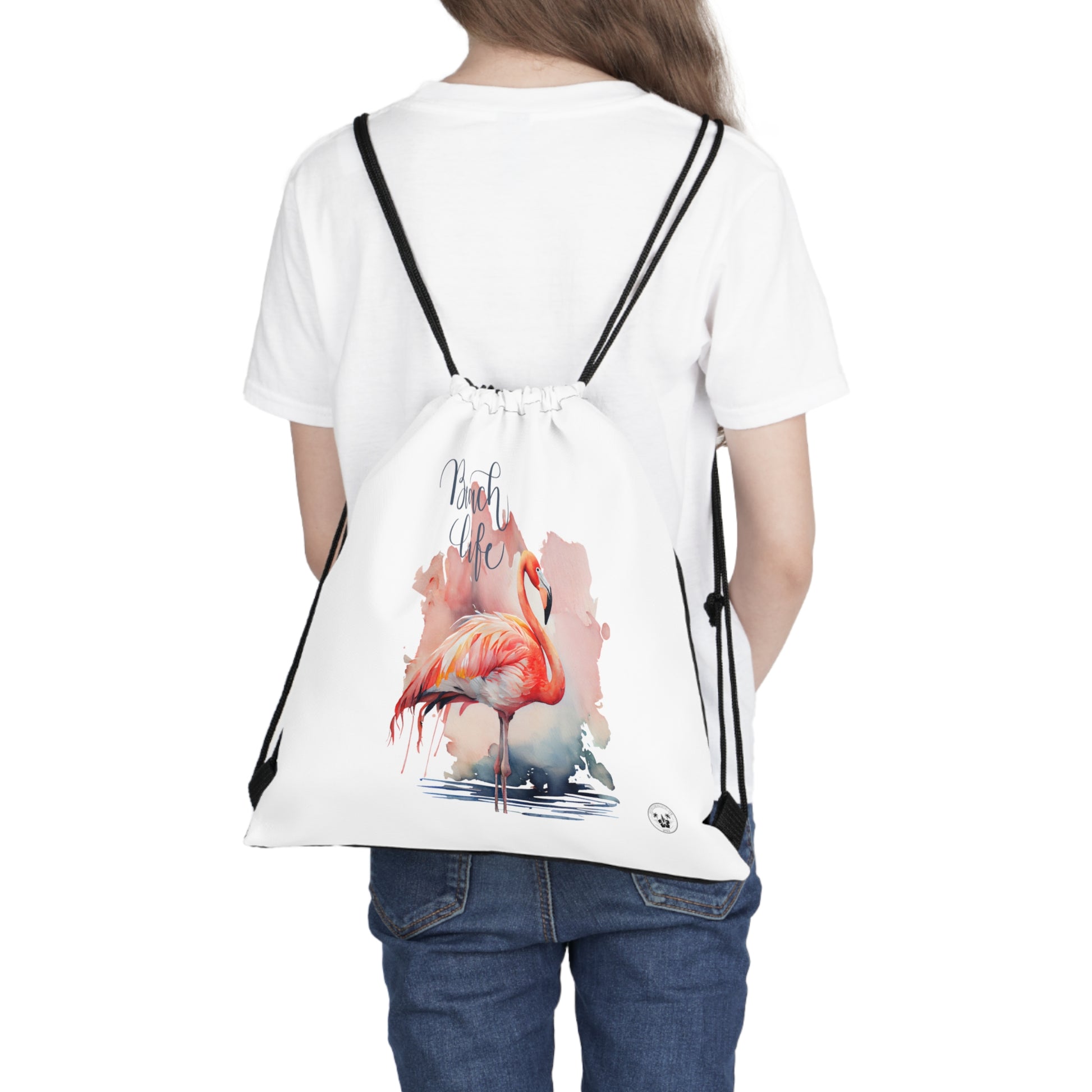 Unleash your wanderlust with our versatile drawstring backpack! Embrace travel with ease and style, flaunting a Beach Life Flamingo graphic with bright color backgrounds. This one is a white background. Designed for adventurers, it's the perfect blend of practicality and fashion. Get yours today for your next adventure! This is a front view of the backpack on the back of a model. 