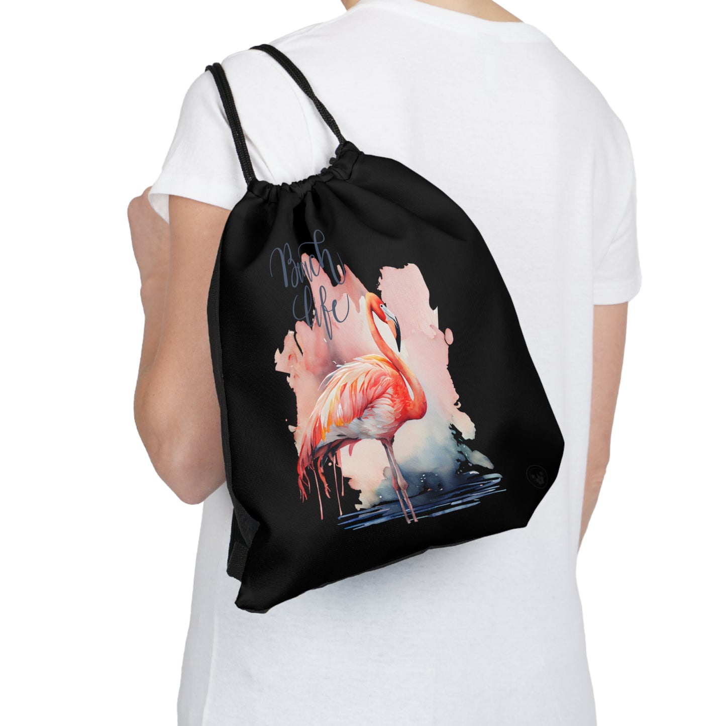 Unleash your wanderlust with our versatile drawstring backpack! Embrace travel with ease and style, flaunting a Beach Life Flamingo graphic with bright color backgrounds. This one is a black background. Designed for adventurers, it's the perfect blend of practicality and fashion. Get yours today for your next adventure! This is a front view of the backpack on the back of a model. 